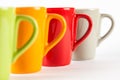 Four color tea cups shown in a row Royalty Free Stock Photo