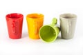 Four color tea cups shown in a row Royalty Free Stock Photo