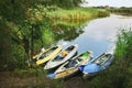 Four colored boats on the shore of small river