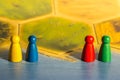 Four colored chips on yellow game board