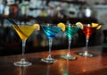 Four colored cocktails on the bar. Yellow, blue, green, red. Decorated with a lemon slice Royalty Free Stock Photo