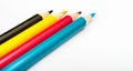 Four colored pencils. The colors cyan, magenta, yellow and black. The concept of polygraphy Royalty Free Stock Photo