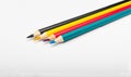 Four colored pencils. The colors cyan, magenta, yellow and black. The concept of polygraphy Royalty Free Stock Photo