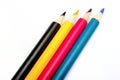 Four colored pencils. The colors cyan, magenta, yellow and black. The concept of polygraphy Royalty Free Stock Photo