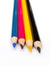 Four colored pencils. The colors cyan, magenta, yellow and black. The concept of polygraphy Royalty Free Stock Photo