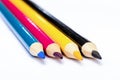 Four colored pencils. The colors cyan, magenta, yellow and black. The concept of polygraphy Royalty Free Stock Photo