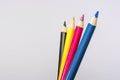 Four colored pencils. The colors cyan, magenta, yellow and black. The concept of polygraphy Royalty Free Stock Photo