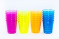 Four colored types of cups on a white background - yellow, orange, pink and blue Royalty Free Stock Photo