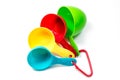 Four colorful ingredient measuring cups Royalty Free Stock Photo