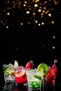 Four colorful tasty alcoholic cocktails in a row at the bar stand.. Festive holiday bokeh Royalty Free Stock Photo