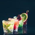 Four colorful tasty alcoholic cocktails in a row at the bar stand.