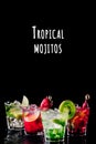 Four colorful tasty alcoholic cocktails in a row at the bar stand. Tropical mojitos wording