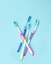 Four colorful toothbrushes. Group of four toothbrushes on a blue background. The concept of healthy teeth in the family Royalty Free Stock Photo