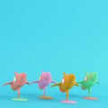 Four colorful toy rockets on bright blue background in pastel colors. Minimalism concept