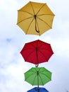 Colorful umbrellas fly through the air on a windy summer day