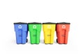 Four colorfull plastic garbage bins with recycling logo, staked on row