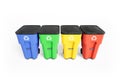 Four colorfull plastic garbage bins with recycling logo, staked on row.