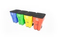 Four colorfull plastic garbage bins with recycling logo, staked on row.
