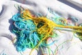 Mess of colored noodles on white cloth