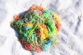 Mess of colored noodles on white cloth