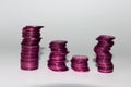 four columns of purple coins on a white background Royalty Free Stock Photo