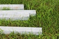 four concrete blocks lie on the grass. blanks for pillars