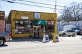 Four Corners Free Market shop surrounded by signs, parked cars and trucks and bare winter trees in Little Five Points in Atlanta Royalty Free Stock Photo