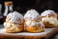 four cream puffs dusted with powdered sugar