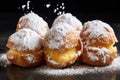 four cream puffs dusted with powdered sugar