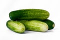 Four cucumbers for fresh vegetables, in a stack composition, isolated on a white background