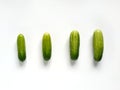 Four cucumbers from small to big