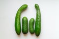 four cucumbers on a white table