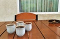 Four cups of coffee stand nearby on the table.