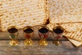 Four cups full of wine with matzah. Jewish holidays Passover