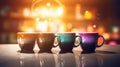 Four cups of hot coffee with a cozy blurred background