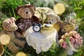 Four cute teddy bear family sitting at the table in the garden Royalty Free Stock Photo