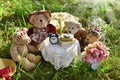 Four cute teddy bear family sitting at the table in the garden Royalty Free Stock Photo