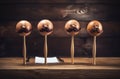 Four cute toy men shaped of wooden balls with moustaches on stick in cute cartoon design with wooden background