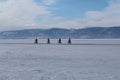 Four cyclists on Baikal lake ice winter Royalty Free Stock Photo