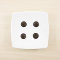 The four dark chocolate buttons and small white square disk