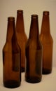 Four dark empty beer bottles.