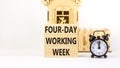 Four-day working week symbol. Concept words Four-day working week on wooden block on a beautiful white table white background. Royalty Free Stock Photo