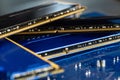 Four DDR memory chips in different colors lying on a blue printed circuit board. Royalty Free Stock Photo