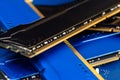 Four DDR memory chips in different colors lying on a blue printed circuit board. Royalty Free Stock Photo