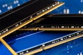 Four DDR memory chips in different colors lying on a blue printed circuit board. Royalty Free Stock Photo