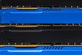 Four DDR memory chips in different colors lying on a blue printed circuit board. Royalty Free Stock Photo