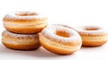Four delicious donuts with icing sugar forming a small stack on white background Royalty Free Stock Photo
