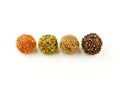 Four different colored balls with nuts and spices on top Royalty Free Stock Photo
