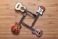 Four different electric and acoustic guitars on a wooden background. Toy guitars. Music concept.