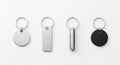 Four Different Metal Keychains Lying Flat on a White Surface key rings silver Royalty Free Stock Photo